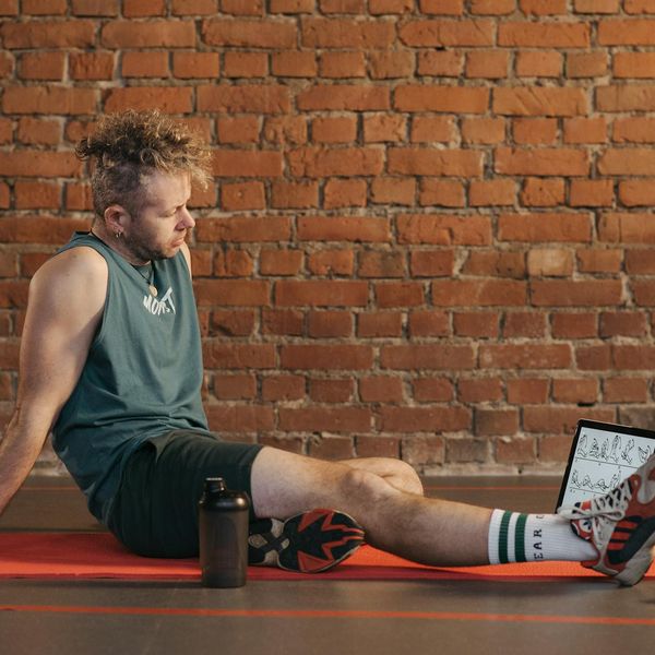 Person feeling refreshed and calm after a workout session, smiling lightly.